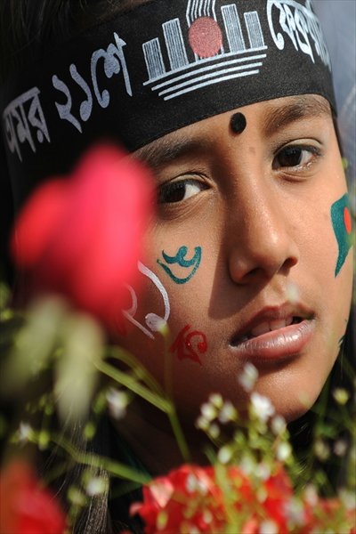 Bangladeshi women participate in a rally at the Central Language Martyrs’ Memorial monument at Dhaka University in Dhaka Tuesday, to pay homage to the martyrs of the 1952 Bengali Language Movement. This marks 60 years since the police fired at thousands of protesters at a university in Bangladesh demanding that Bengali be declared the state language. Photo: AFP