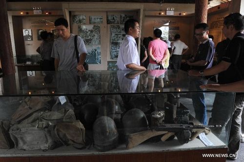 Visitors learn about the battle against Japan's invasion in a museum in Tengchong, Southwest China's Yunnan Province, August 15, 2012. Many visitors came to the cemetery for martyrs and museums to mark the 67th anniversary of Japan's World War II surrender. Tengchong was a frontline where Chinese people fought against Japan's invasion during the World War II. Photo: Xinhua