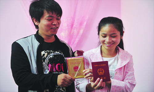 Qiu Jian and Li Jie show their marriage certificate. Photo: CFP