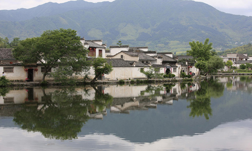 Hongcun village is located in Yixian county at the foot of the southwestern slope of Huangshan Mountain, Anhui Province. With morning mist, stone bridges, white walls, water lily ponds and hills, it has been described as a village out of a traditional Chinese ink painting. Besides halls, pavilions and temples, the village consists of 160 ancient residences. These architectures, with fantastic stone carvings, were built during the Ming and Qing dynasties and widely regarded as the best historic sites throughout China. Photo: China.org.cn