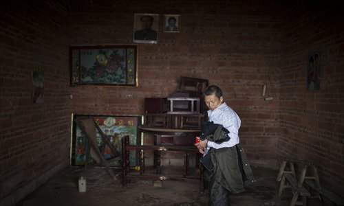 Wang looks around his living room upon arriving home.