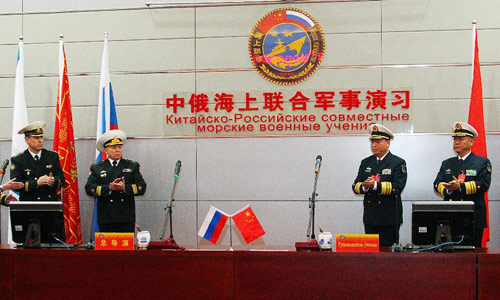 Ding Yiping (2nd L), deputy commander of the Navy of the Chinese People's Liberation Army, and Rear Admiral Leonid Sukhanov (2nd R), Russian naval deputy chief of staff, attend the starting ceremony of the Russia-China joint naval exercise in Qingdao, east China's Shandong Province, April 22, 2012. The Russia-China joint naval exercise, scheduled to be held from April 22 to 27 in the Yellow Sea of the Pacific Ocean, officially started on Sunday morning. The drill involves a total of 16 vessels and two submarines from the Chinese Navy and four warships from the Russian Navy's Pacific Fleet as well as three supply ships. The exercise will focus on joint maritime air defense and defense of marine traffic arteries, including subjects of joint escort, maritime search and rescue, anti-submarine tactics as well as joint effort to rescue hijacked vessels. Photo: Xinhua
