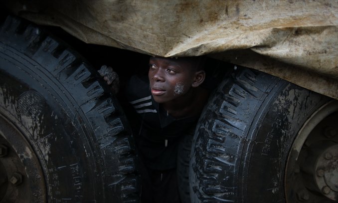 An internally displaced Congolese boy shelters from the rain under a truck in the Mugunga III IDP camp in the east of the Democratic Republic of the Congo on Sunday.  UN refugee agency officials reported cases of looting and rape in an attack on the giant Mugunga camp, which lies about 10 kilometers west of Goma and is home to up to 35,000 displaced people. Photo: AFP