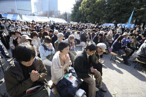  People attend a mourning ceremony in Tokyo, capital of Japan, on March 11, 2013. A mourning ceremony was held here Monday to mark the two year anniversary of the March 11 earthquke and ensuing tsunami that left more than 19,000 people dead or missing and triggered a nuclear accident the world had never seen since 1986. (Xinhua/Kenichiro Seki) 