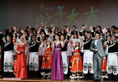 Chinese students studying in Russia take curtain call and wave hands to audiance during a performance staged at the Chinese Embassy in Moscow, Russia, Jan. 20, 2013. The performance was held here on Sunday in celebration of China's traditional Spring Festival and the upcoming Year of the Snake. (Xinhua/Jiang Kehong)