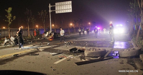 Rescuers work at the accident site after a car with eight passengers collided with a trailer in Wenzhou City, east China's Zhejiang Province, May 12, 2013. Seven people were killed and one other injured in the accident, which ocurred at midnight on Saturday. (Xinhua)