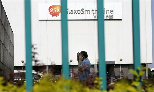 A guard walks in the yard of the GlaxoSmithKline company at the Zhangjiang Innovation Park, Shanghai, on July 16, 2013. Photo: CFP