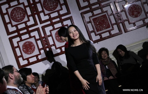 Chinese designer Chu Yan appears at the end of her fashion show at Chinese Cultural Center in Paris, France, Feb. 25, 2013. (Xinhua/Gao Jing) 