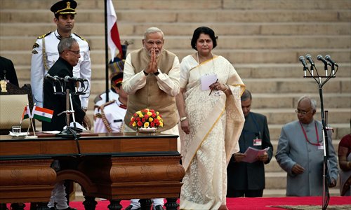 Modi (center) greets attendees moments before taking the oath of office on Monday. Modi was sworn in as prime minister with the strongest mandate of any leader for 30 years, promising to forge a 