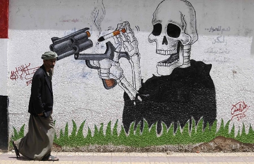 A Yemeni man passes a wall with anti-smoking graffiti in Sanaa, Yemen, on April 7, 2013. The World Health Day is celebrated on April 7 to mark the 65th anniversary of the World Health Organization that was established in 1948. The theme for 2013 is high blood pressure. The Yemeni government has been trying to restore medical services in the country after the unrest in 2011 hit hard the cash-stripped Arab state. (Xinhua/Mohammed Mohammed) 