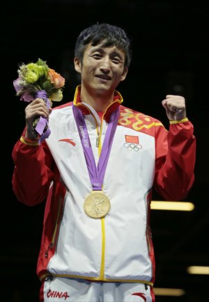 Inset: Zou Shiming celebrates with his gold medal. Photos: IC