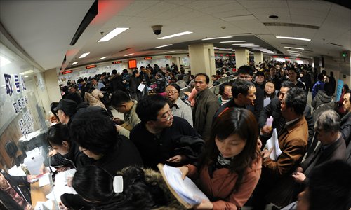 Residents of Nanjing in Jiangsu Province crowd in a real estate transaction center. The State Council unveiled new policies aiming to further rein in sky-high housing prices, prompting home owners in major cities to sell their houses before the measures take effect. Photo: CFP