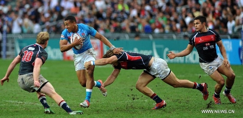 Marcus Watson (L2) of England breaks through during a match against Hong Kong of China at the Hong Kong Sevens rugby tournament in south China's Hong Kong, March 24, 2013. England won the match 42-7 to win the 9th place. (Xinhua/Lo Ping Fai) 