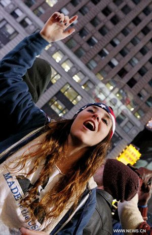 Supporters of U.S. President Barack Obama react as they watch election results broadcast confirming the re-election of President Barack Obama at Times Square in New York, November 6, 2012. Photo: Xinhua