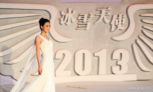 A contestant is pictured on a evening wear show during a beauty contest in Changchun City, capital of northeast China's Jilin Province, Dec. 19, 2012. Photo: Xinhua