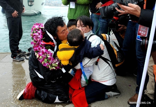 China's Guo Chuan (1st L) celebrates with his family after returning home in Qingdao, east China's Shandong Province, April 5, 2013. Guo sailed back home on Friday morning to become the first Chinese to successfully circumnavigate the globe singlehanded. Aboard his Class40 yacht, 48-year-old Guo travelled about 21,600 nautical miles in 138 days before he returned to his hometown of Qingdao, where he set off on November 18 last year. (Xinhua/Li Ziheng)