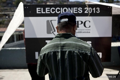 A citizen casts his vote during the election day in the Lomas Taurinas suburb in Tijuana, Baja California, Mexico, on July 7, 2013. On Sunday, elections took place in Mexico's 14 states, where state legislatures and mayorships would be renewed. (Xinhua/Guillermo Arias) 