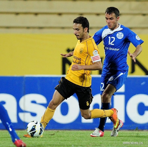 Salh Al Shikh (L) of Kuwait's Qadsia SC vies with Rustamov hasan of Tajikistan's Ravshan SC during their AFC Cup football match in Kuwait City, Kuwait, on April 3, 2013. Qadsia won the match 3-0. (Xinhua/Noufal Ibrahim) 