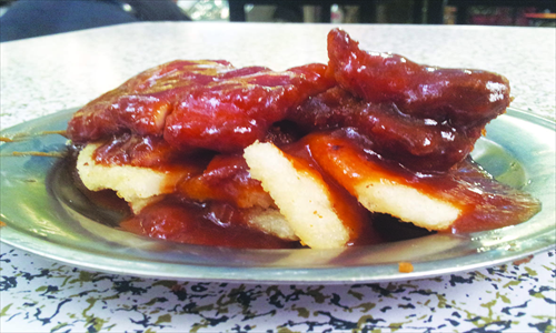 a plate of fried pork chops and sticky rice cakes Photo: Courtesy of Kyle J. Mitchell