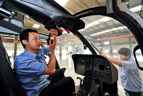 Workers do product test in a factory of AVIC Helicopter LLC. in north China's Tianjin Municipality, October 16, 2012. Tianjin is shaping its aviation and aerospace industry based on the making of aircrafts, large rockets, satellites and space labs. The total output value of the city's aviation and aerospace industry reached 22.77 billion yuan ($3.6 billion) in 2011, growing 33.8 percent on a year-on-year basis. Photo: Xinhua