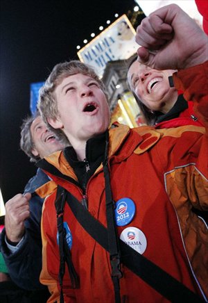 A supporter of U.S. President Barack Obama reacts as he watches election results broadcast confirming the re-election of President Barack Obama in New York, November 6, 2012. Photo: Xinhua