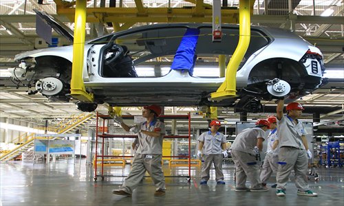 Workers put together cars on the production line at the new FAW-Volkswagen Foshan plant that opened on September 25. Photo: CFP