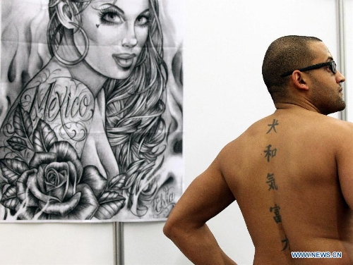 A man shows his tattoo during the 21st International Tattoo Convention in Frankfurt, Germany, March 22, 2013. The Tattoo Convention kicked off on Friday and will last for three days. (Xinhua/Luo Huanhuan)