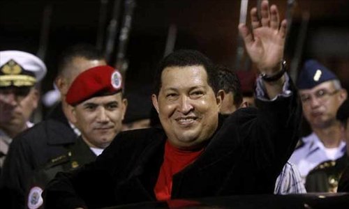 File photo taken on March 16, 2012 shows Venezuelan President Hugo Chavez greeting his supporters on his arrival at the Simon Bolivar International Airport of Maiquetia, Caracas, Venezuela. Venezuelan government confirmed President Hugo Chavez's death on March 5, 2013. Photos: Xinhua