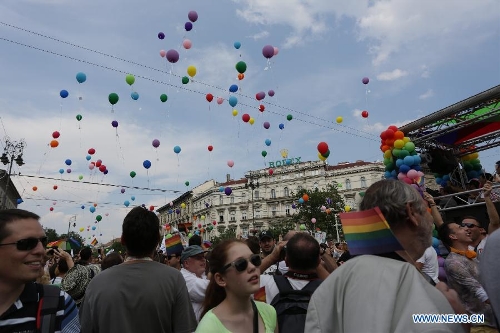 Participants release balloons with their wishes attached to them as they march across the city during the Gay Pride Parade in Budapest, Hungary on July 6, 2013. (Xinhua/Attila Volgyi) 