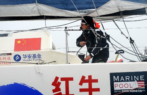 China's Guo Chuan sails toward the shore in Qingdao, east China's Shandong Province, April 5, 2013. Guo sailed back home on Friday morning to become the first Chinese to successfully circumnavigate the globe singlehanded. Aboard his Class40 yacht, 48-year-old Guo travelled about 21,600 nautical miles in 138 days before he returned to his hometown of Qingdao, where he set off on November 18 last year. (Xinhua/Li Ziheng)