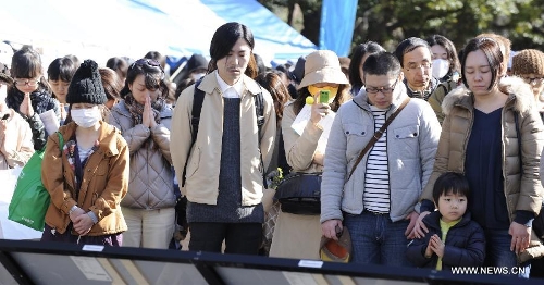 People attend a mourning ceremony in Tokyo, capital of Japan, on March 11, 2013. A mourning ceremony was held here Monday to mark the two year anniversary of the March 11 earthquke and ensuing tsunami that left more than 19,000 people dead or missing and triggered a nuclear accident the world had never seen since 1986. (Xinhua/Kenichiro Seki) 