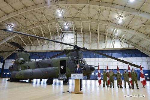 Canadian Defense Minister Peter MacKay addresses the unveiling ceremony of new CH-147F Chinook helicopters in Ottawa June 27, 2013. The 15 newly purchased F-model Chinooks will be engaged in support, domestic and foreign operations for the Royal Canadian Air Force's reactivated 