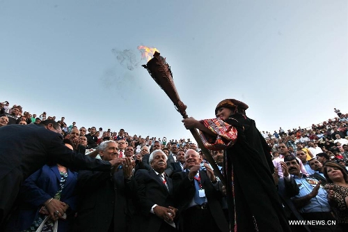 A Jordanian girl carries the torch of the Festival during the opening ceremony of Jordan's annual Jerash Festival, hosted in the ancient Greco-Roman city, 45 km north of Amman, on June 26, 2013. (Xinhua/Mohammad Abu Ghosh) 