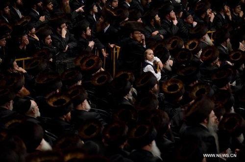 Jews of the Belz Hasidic Dynasty watch the wedding ceremony of Rabbi Shalom Rokeach, the grandson of the Belz Rabbi Yissachar Dov Rokeach, at the neighbourhood of Kiryat Belz in Jerusalem on May 21, 2013. More than 10,000 Jews participated in the wedding. (Xinhua/Yin Dongxun) 