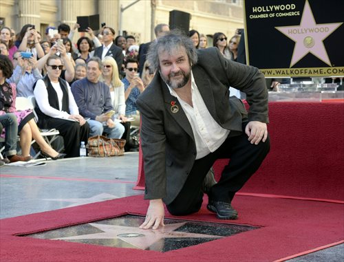 peter jackson poses with his new walk of fame star in hollywood