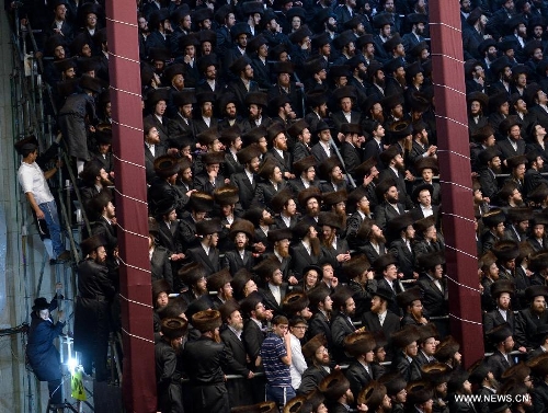 Jews of the Belz Hasidic Dynasty watch the wedding ceremony of Rabbi Shalom Rokeach, the grandson of the Belz Rabbi Yissachar Dov Rokeach, at the neighbourhood of Kiryat Belz in Jerusalem on May 21, 2013. More than 10,000 Jews participated in the wedding. (Xinhua/Yin Dongxun) 