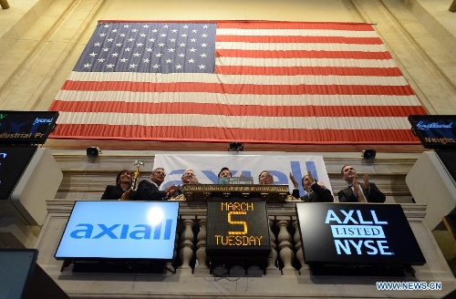 Guests cheer after ringing the closing bell at the New York Stock Exchange on March 6, 2013. U.S. stocks surged on Tuesday, with the Dow Jones Industrial Average setting all-time closing high and intra-day high, as investors became more confident in the stock market. (Xinhua/Wang Lei) 