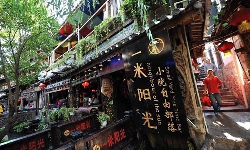 Tourists walk in the old town of Lijiang, southwest China's Yunnan Province, Aug. 8, 2012. The old town of Lijiang, a UNESCO World Heritage site with a history of more than 800 years, was formally licenced as the national 5A tourism attraction spot, the top one among China's tourism ranking system, on July 27, 2011. During the first six months of 2012, in total 8.0934 million people visited Lijiang, increasing by 55.93 percent year on year. The tourism industry's revenue of the same period reached 10.395 billion yuan ($1.634 billion), growing by 56.14 percent. Photo: Xinhua