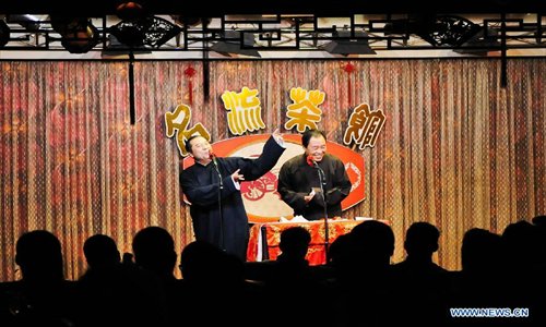 Cross talk actors perform on stage at a teahouse in Tianjin, north China, January 2, 2013.