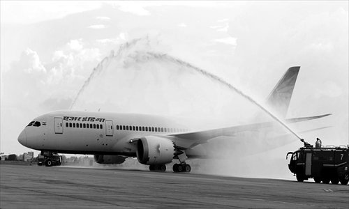 Air India's first Boeing 787 Dreamliner aircraft is given a water canon salute after it touched down at the Indira Gandhi International Airport in Delhi, India on Saturday. The aircraft is the first of the 27 256-seater aircraft ordered by the state-run airline. Photo: CFP