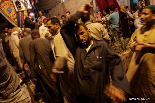 Egyptians perform Sufi dancing during a celebration of the birth anniversary of Sayeda Zainab, who is the granddaughter of Prophet Muhammad, in Cairo, Egypt, June 5, 2013. (Xinhua/Amru Salahuddien) 