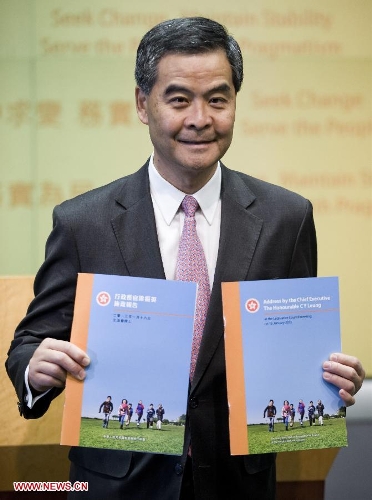  Hong Kong Chief Executive Leung Chun-Ying poses with the print version of his 2013 Policy Address at a press conference in Hong Kong, south China, Jan. 16, 2013. Leung delivered his first policy address on Wednesday morning at the Legislative Council here, outlining the city government's policy direction in 2013. (Xinhua/Lui Siu Wai) 