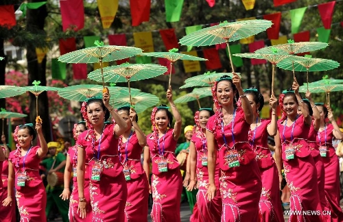 Girls of the Dai ethnic group perform at a carnival during the China Kunming Culture and Tourism Festival in Kunming, capital of southwest China's Yunnan Province, April 29, 2013. (Xinhua/Lin Yiguang)  