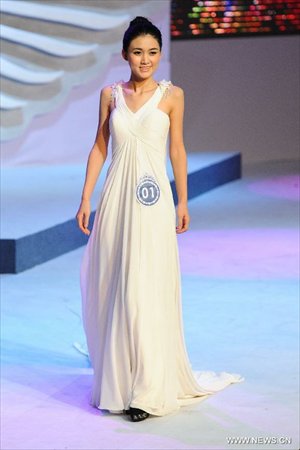 A contestant is pictured on a evening wear show during a beauty contest in Changchun City, capital of northeast China's Jilin Province, Dec. 19, 2012. Photo: Xinhua