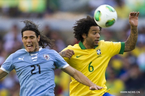 Brazil's Marcelo (R) vies for the ball with Edinson Cavani (L) of Uruguay, during the FIFA's Confederations Cup Brazil 2013 semifinal match, held at Mineirao Stadium, in Belo Horizonte, Minas Gerais state, Brazil, on June 26, 2013. (Xinhua/StraffonImages)