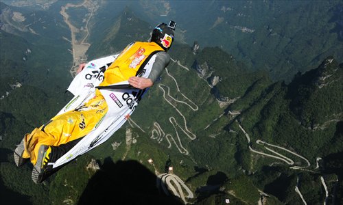 A flier in a wingsuit trains Wednesday ahead of the World Wingsuit Championship   that is taking place from October 11 to 13 at the Zhangjiajie National Park in Hunan Province. An accident which killed a participant on Tuesday has drawn nationwide attention. Photo: CFP