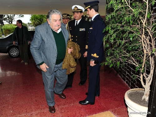 Image provided by Uruguay's Presidency shows President of Uruguay Jose Mujica (L) leaving for Bolivia, in Montevideo, Uruguay, on July 4, 2013. Jose Mujica left for Bolivia to attend the emergency meeting of the Union of South American Nations (UNASUR, by its acronym in Spanish). (Xinhua/Uruguay's Presidency)