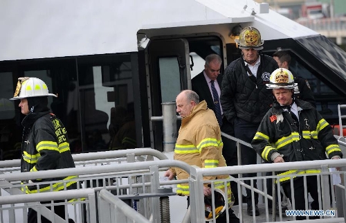  Firefighters work on a ferry boat which crashed into Pier 11 in lower Manhattan, New York, the United States, on Jan. 9, 2013. A high-speed ferry loaded with hundreds of commuters from New Jersey crashed into a dock near Wall Street on Wednesday during the morning rush hour, injuring 57 people. (Xinhua/Shen Hong) 