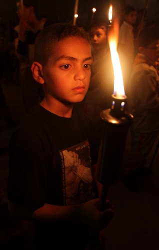 A Palestinian boy holds a torch during a rally in the West Bank city of Tubas on May 14, 2013, to mark Nakba Day on May 15, the annual day of commemoration of the displacement of Palestinians after the establishment of the state of Israel in 1948. (Xinhua/Ayman Nobani) 