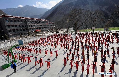 Pupils do exercises at No. 1 Primary School of Deqin County in Diqing Tibetan Autonomous Prefecture, southwest China's Yunnan Province, March 12, 2013. A total of 1,260 pupils, most of whom are of the Tibetan ethnic group, study at this school, which was founded in September 2012. Pupils here are offered free meals and lodging. (Xinhua/Lin Yiguang)  